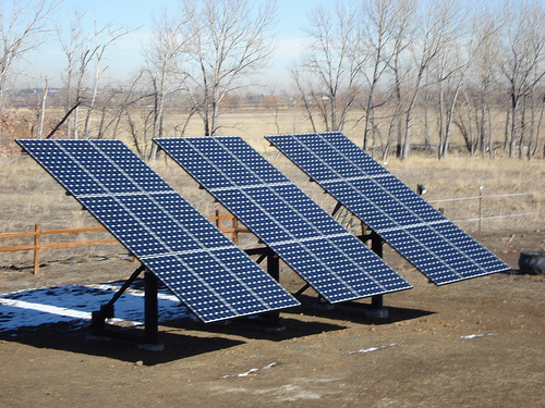 Single/double pole solar panel ground mounting system with cement block foundation