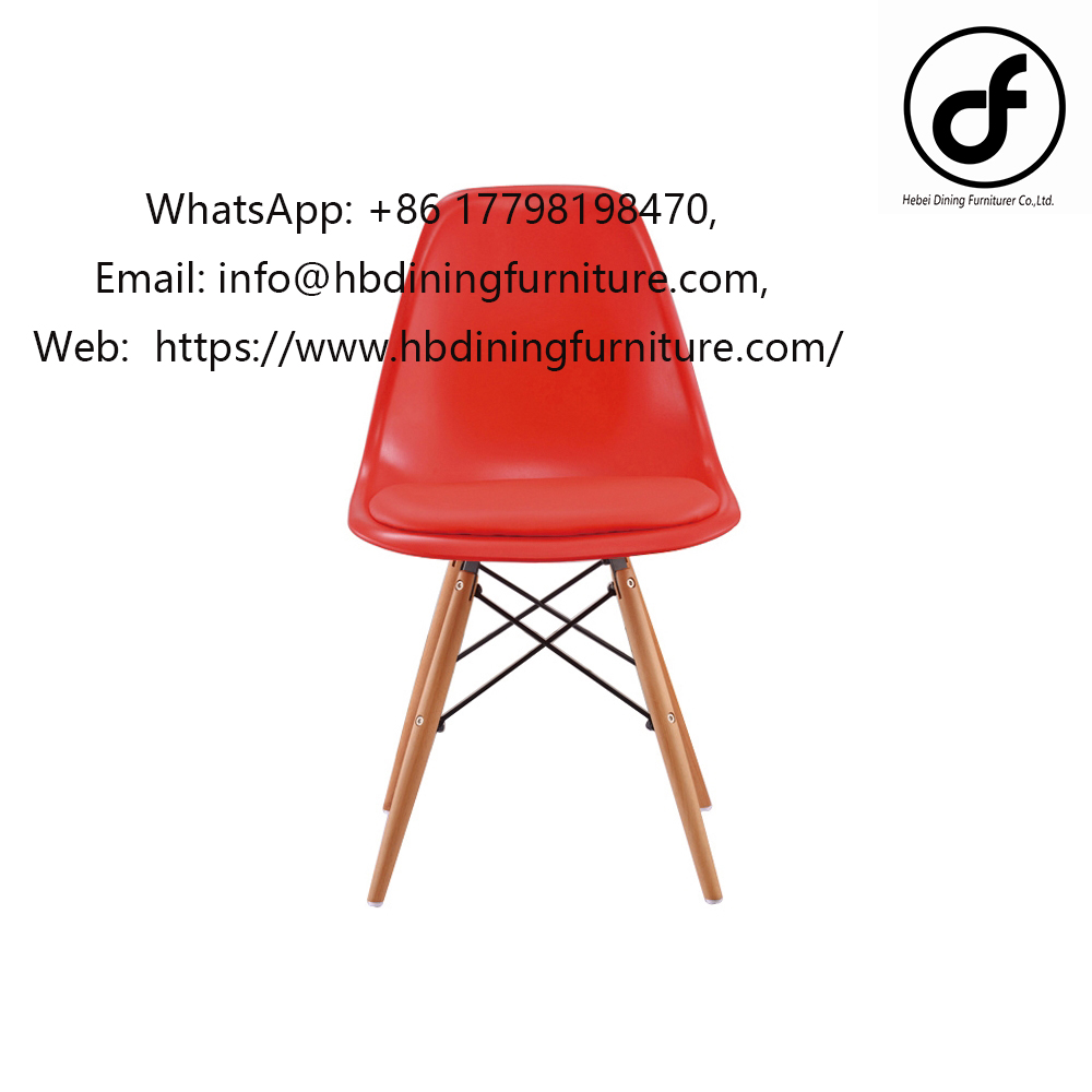 Red plastic dining chair with wooden legs